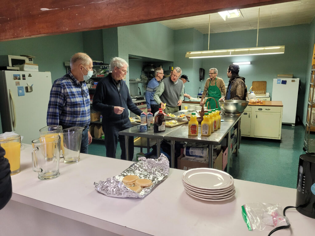 The men of Waverly Presbyterian standing in the kitchen after a long morning's work