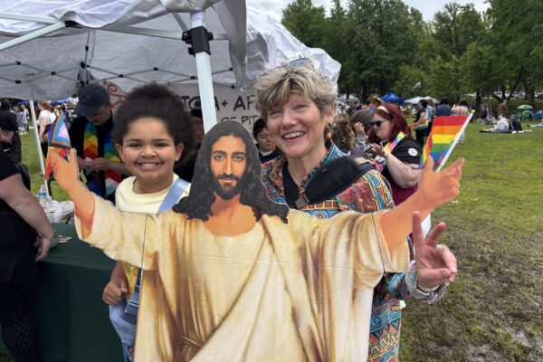 Two people smiling at outside event