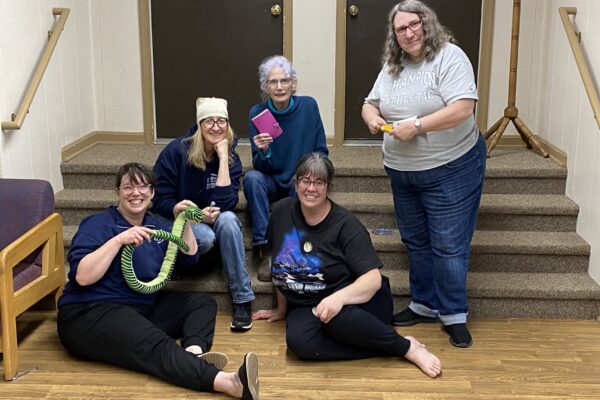 5 women sitting on stairs
