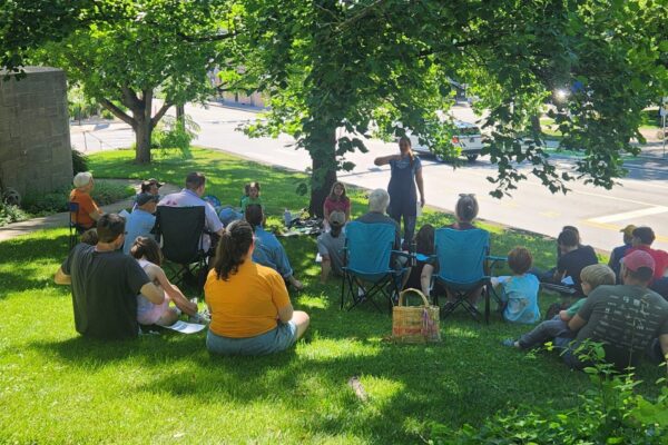 Group of people sitting on lawn
