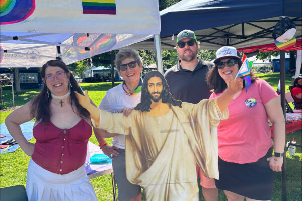 Group standing in front of booth